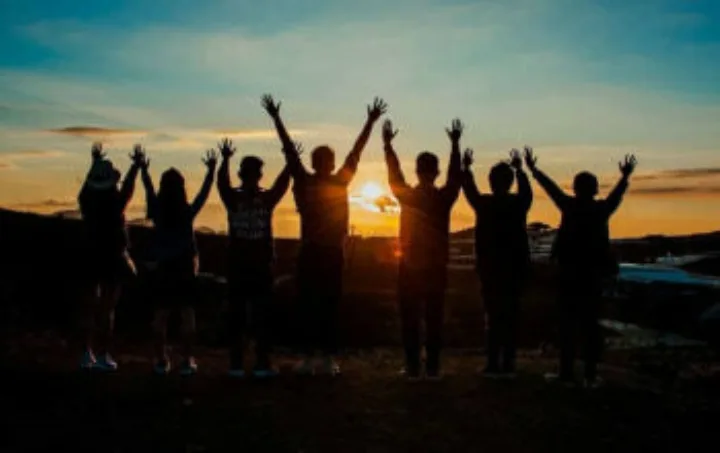 Group of people with arms aloft.